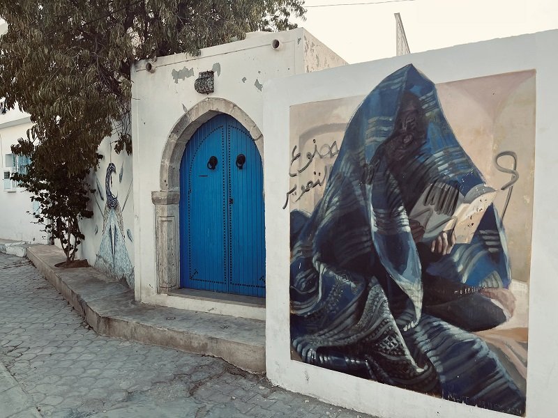 Djerbahood art next to Tunisia blue door